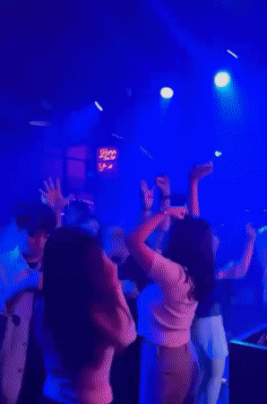 Nightclub scene with dancing and bar atmosphere in Medan