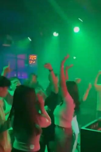 Nightclub scene with dancing and bar atmosphere in Medan