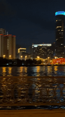 Late-night acoustic guitar session on a Yekaterinburg waterfront walkway
