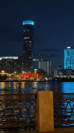 Late-night acoustic guitar session on a Yekaterinburg waterfront walkway