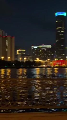 Late-night acoustic guitar session on a Yekaterinburg waterfront walkway