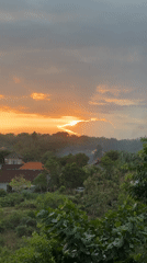 Golden sunset over red-roofed Kuta Selatan neighborhood
