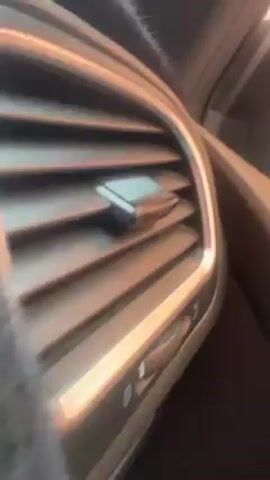The video shows a gray dashboard cover in a car, with the word "GOLF" embroidered in red. The cover is placed over the passenger side of the dashboard, partially obscuring the air vent. The camera moves slightly, revealing more of the dashboard cover and the embroidered word.