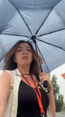 Sheltering under a dark umbrella on a Kryvyi Rih street
