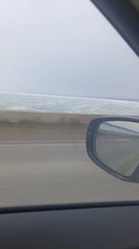 Car journey filmed along waterside road in Chaykovsky