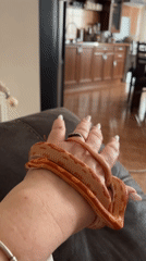 Person handles orange corn snake indoors during brief encounter