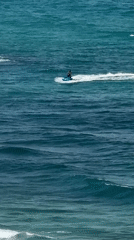 Netanya beach buzzing with water sports on a clear morning