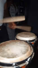 Person plays drums and pool in late-night session