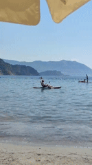Paddleboarding, floats, and cold drinks on a sunny beach day