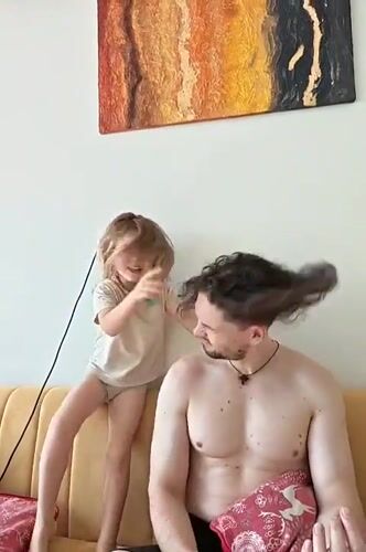 Father and child share playful moment on couch in Mumbai