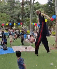 Stilt performer entertains children at Tel Aviv park event