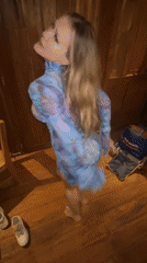 Woman dances with cat in wooden room, Sidemen