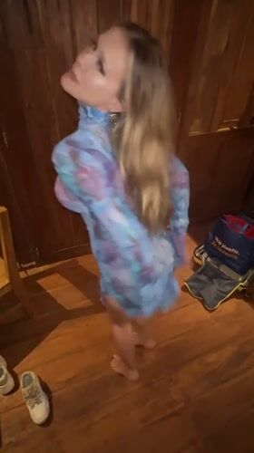 Woman dances with cat in wooden room, Sidemen