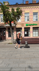 Saxophone player on a Gatchina sidewalk near an Orthodox church