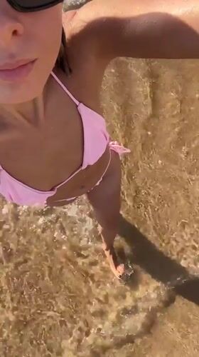Woman in pink bikini enjoys beach time in Nha Trang