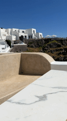 Coffee break overlooking Santorini's iconic white cliffside architecture