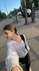 Woman photographs herself among lilac blooms in Saint Petersburg