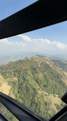 Helicopter flight documents green mountain landscapes near Kathmandu