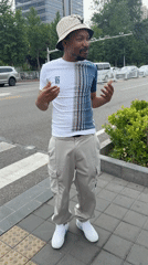 Man gestures on sidewalk in Beijing's Daxing District