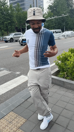 Man gestures on sidewalk in Beijing's Daxing District