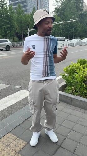 Man gestures on sidewalk in Beijing's Daxing District