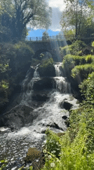 Waterfall with stone bridge captured in Thornliebank countryside