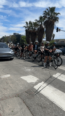 Cyclists pause at crosswalk in Los Angeles
