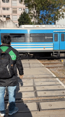Buenos Aires pedestrians wait for public train at crossing