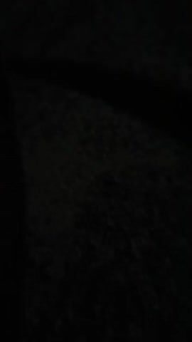 THE VIDEO IS EXTREMELY DARK AND DIFFICULT TO DISCERN ANY DETAILS. IT APPEARS TO BE A CLOSE-UP SHOT OF A DARK, TEXTURED SURFACE, POSSIBLY ASPHALT OR CONCRETE. THERE ARE SOME FAINT, CURVED LINES VISIBLE ON THE SURFACE, WHICH COULD BE SCRATCHES, TIRE MARKS, OR NATURAL FISSURES. THE LIGHTING IS MINIMAL, SUGGESTING THE FOOTAGE WAS FILMED AT NIGHT OR IN A VERY DIMLY LIT AREA. NO PEOPLE, OBJECTS, OR SPECIFIC ACTIONS ARE CLEARLY IDENTIFIABLE.