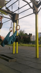 Person performs inverted ring exercises in Burgas park