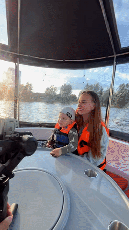 Mother and child enjoy afternoon boat trip on Kazanka River