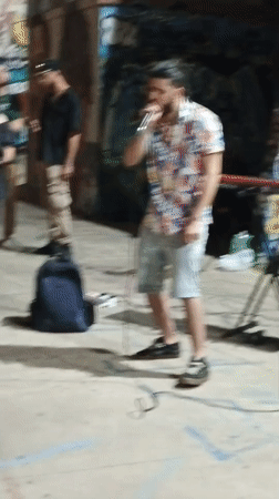 Late-night street performance in Rome, graffiti walls and all