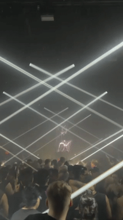 DJ performs at New York nightclub with dramatic lighting