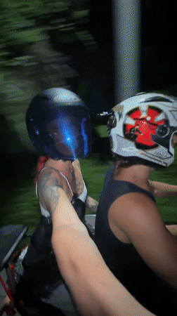 Two motorcyclists captured on camera during night ride in Kuta