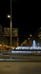 Illuminated fountain captured at Barcelona roundabout during evening hours