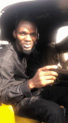 Men in rickshaw make gestures in Jos, Nigeria