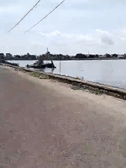 Excavator operates from water platform in Lhokseumawe, Indonesia