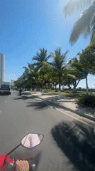 Motorcycle journey captured along Nha Trang's sunny coastal roads