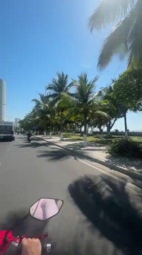 Motorcycle journey captured along Nha Trang's sunny coastal roads