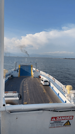Ferry sails calm waters near Keramoti, Greece
