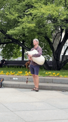 Bagpiper performs in Sofia park as pedestrians pass by
