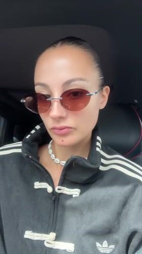 Woman in Adidas tracksuit films selfie in car, Wichit Thailand