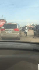 Gold minivan draws crowd on busy Abuja street