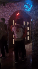 Couples dance in crowded Bangkok bar with tropical decor