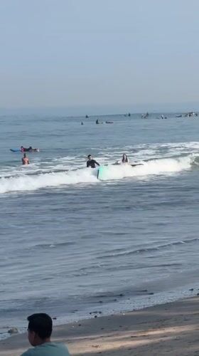 Kuta Beach surf session with boards, waves, and beachside downtime