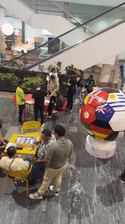 Trading card enthusiasts exchange soccer cards at Puebla mall