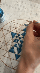 Artist applies blue paint to geometric design in Novosibirsk