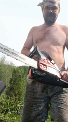 Man operates chainsaw outdoors in Motyakovo, Russia