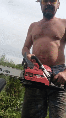 Man operates chainsaw outdoors in Motyakovo, Russia
