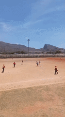 Baseball practice observed in rural Venezuela under mountain backdrop